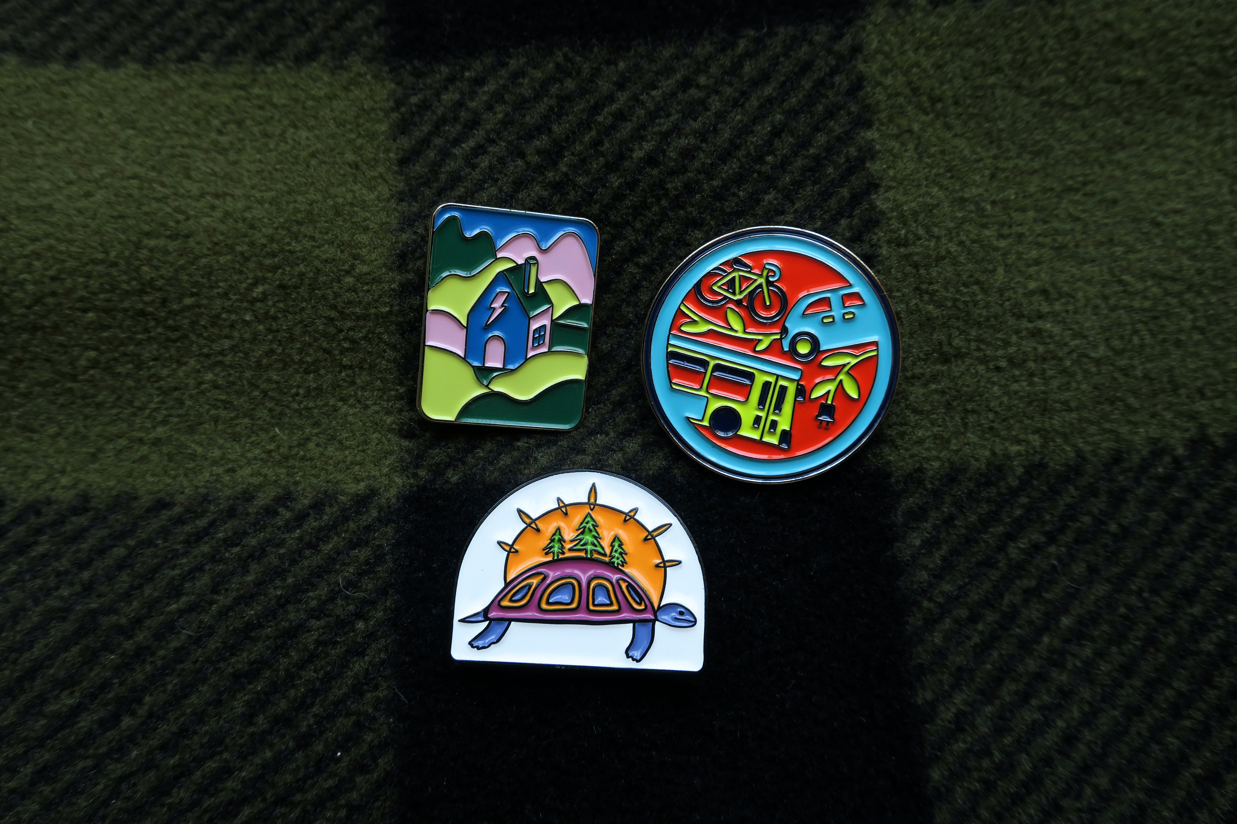 three badges on a dark blanket