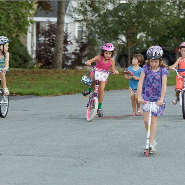 kids riding bikes and scooters