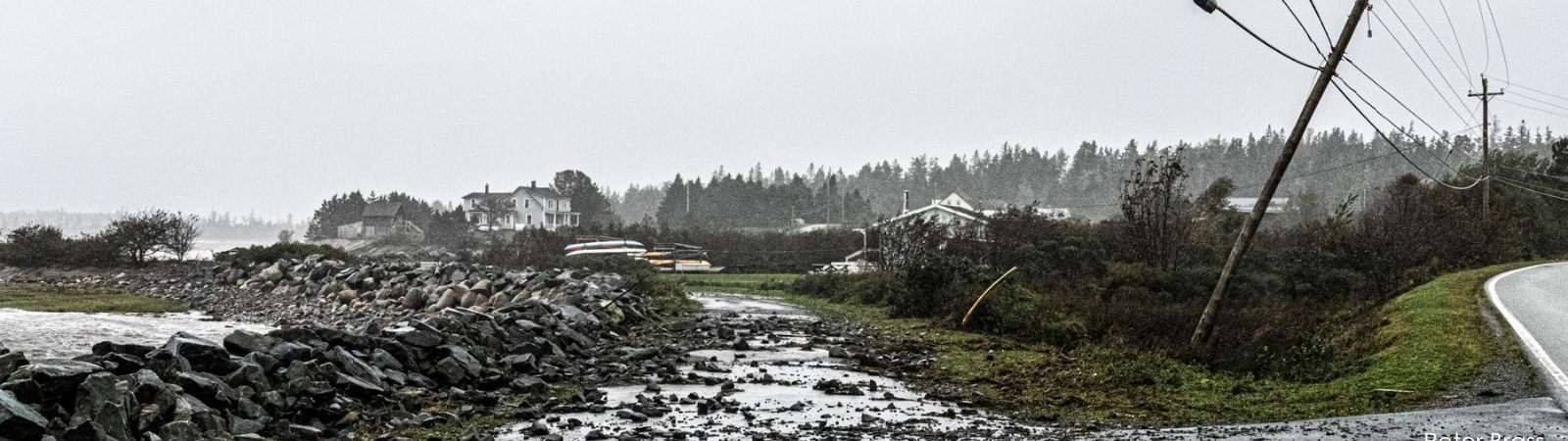 the sea spills over a seawall following a hurricane