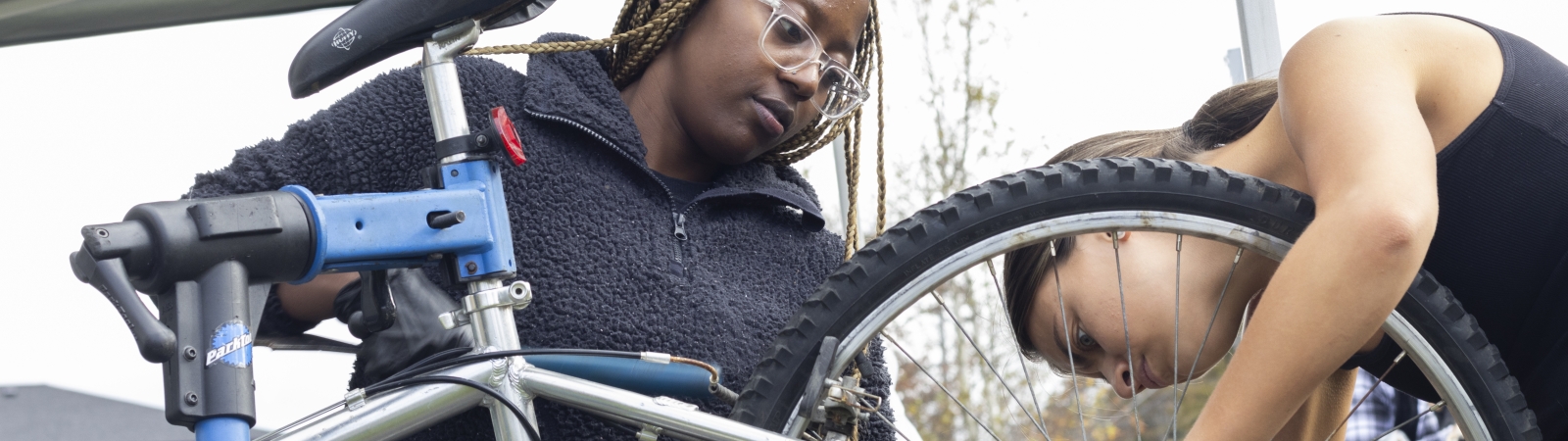 two women repairing a bike