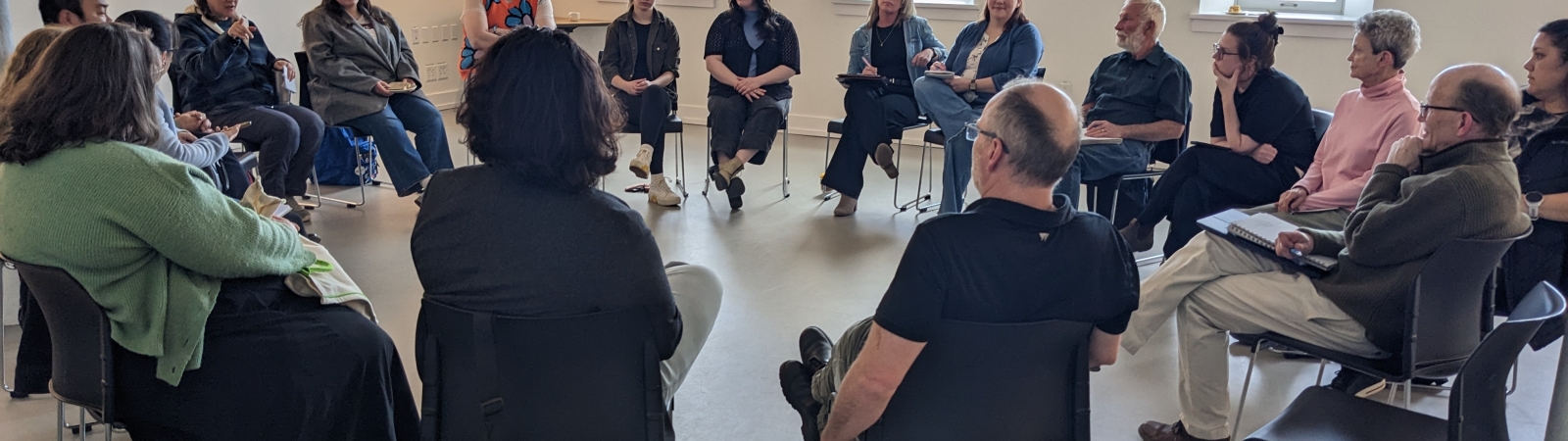 a circle of people sitting in chairs