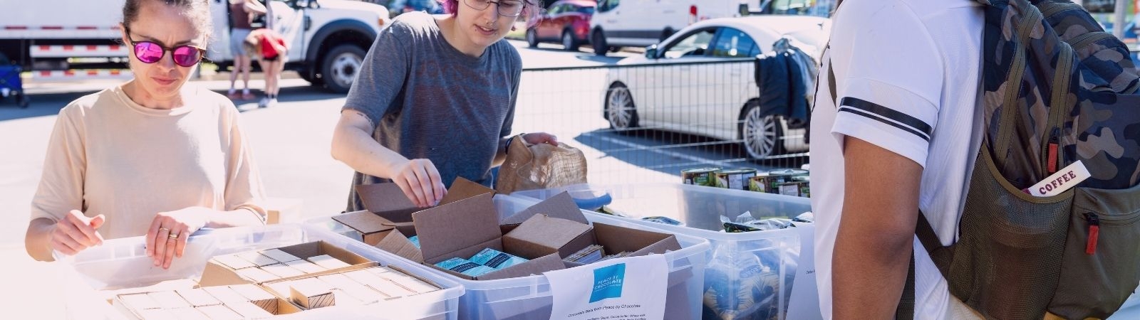 people handing out supply kits in community