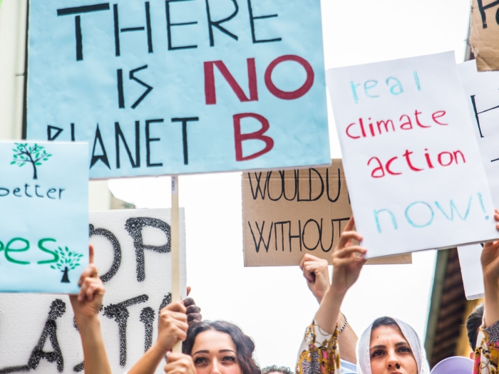 People holding signs at a climate rally.