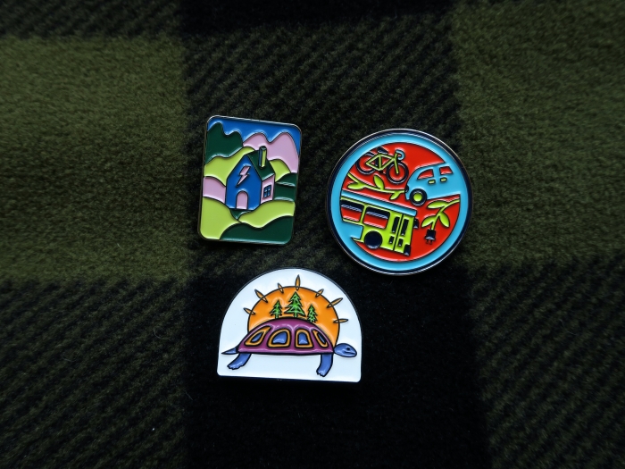 three badges on a dark blanket