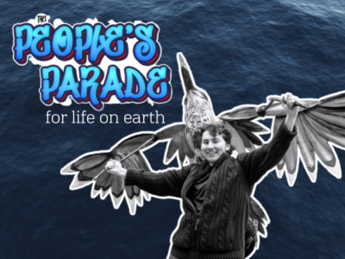 a black and white photo of a person with a bird puppet against a wavy blue water background. beside the person, bubble text reads "The People's Parade for Life on Earth"