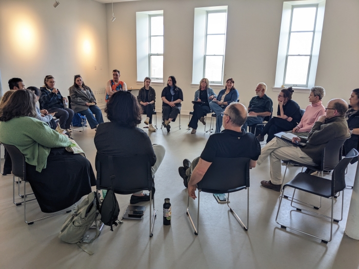 a circle of people sitting in chairs