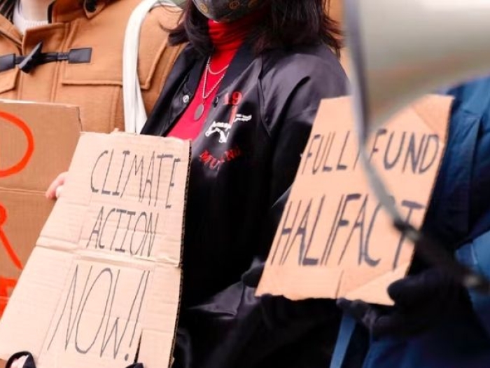 Teens holding climate protest signs