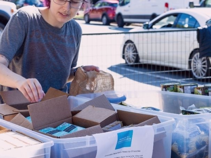 people handing out supply kits in community